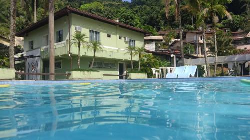 a large swimming pool in front of a house at Casa da Baía in Angra dos Reis