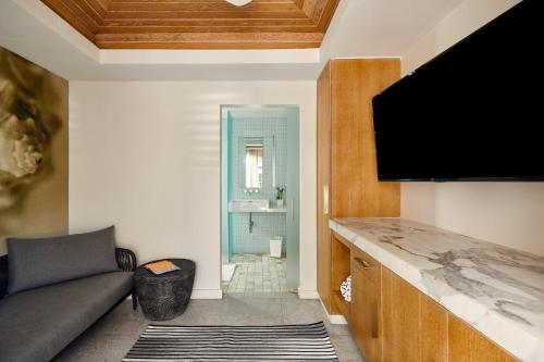 a living room with a couch and a flat screen tv at Loews Miami Beach Hotel in Miami Beach