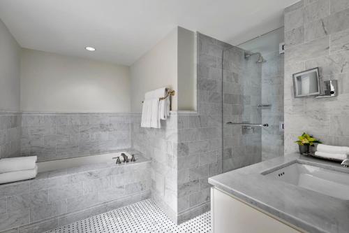 a bathroom with a tub and a sink at Loews Regency New York Hotel in New York