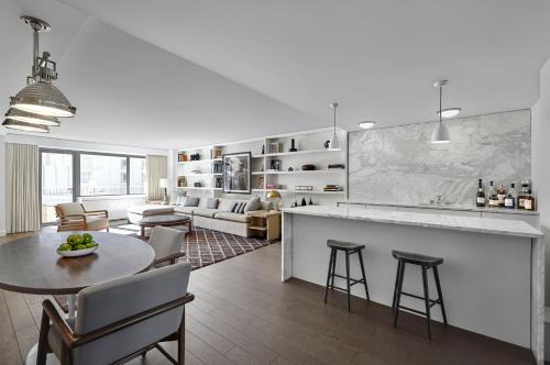 a kitchen and living room with a table and chairs at Loews Regency New York Hotel in New York
