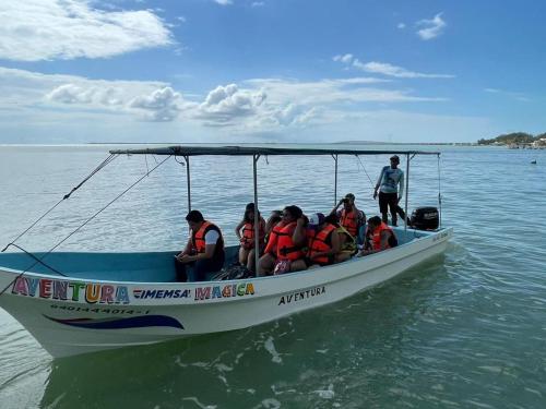 a group of people in a boat on the water at HOTEL ISLA in Isla Aguada