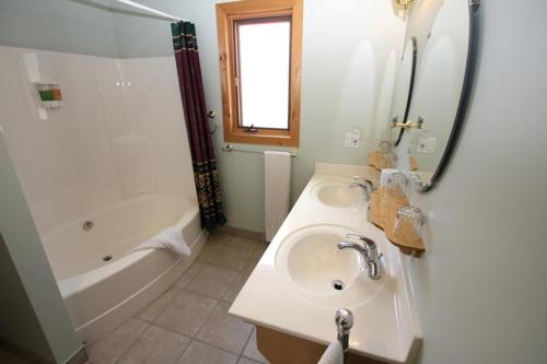 a bathroom with a sink and a tub and a shower at Glenogle Mountain Lodge and Spa in Golden