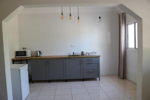 a kitchen with a sink and a counter top at The Rink Apartment's in Sukuta