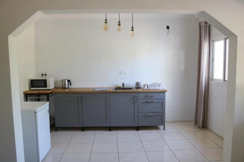 a kitchen with a sink and a counter top at The Rink Apartment's in Sukuta
