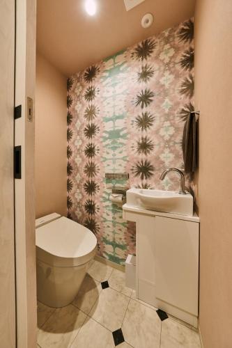 a bathroom with a toilet and a sink at Hotel TORACO konohana in Osaka