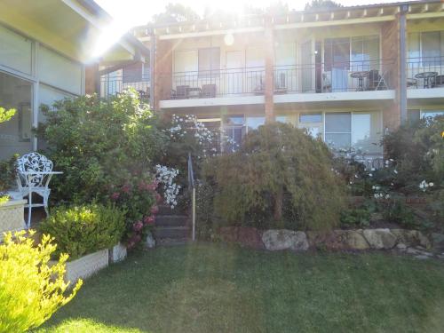 an apartment building with a lawn in front of it at Golfview Lodge in Bowral