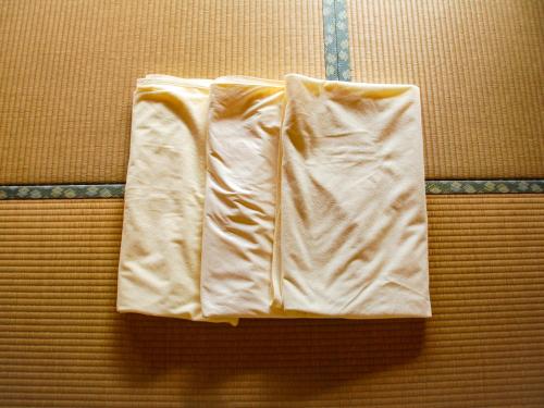 a towel is hanging on a wall at Kokoyui Guest House in Nachikatsuura