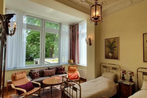 a living room with a bed and a couch and a table at Ferienwohnungen Villa Haniel Carl in Dresden