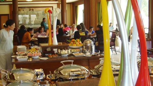 a buffet of food in a restaurant with people eating at Avari Towers Karachi in Karachi
