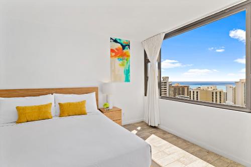 A bed or beds in a room at Cozy Ocean View Escape, 1 Block to Beach with Free Parking