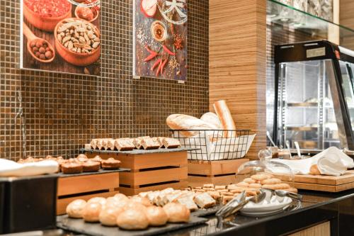 a bakery with bread and pastries on a counter at Radisson Collection Hotel, Yangtze Shanghai in Shanghai