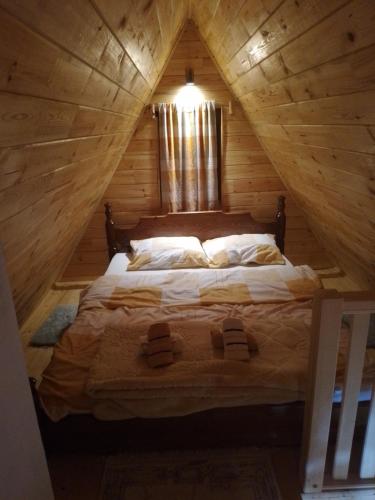 a bedroom with a bed in a wooden cabin at Etno Koliba Nikoleta in Žabljak