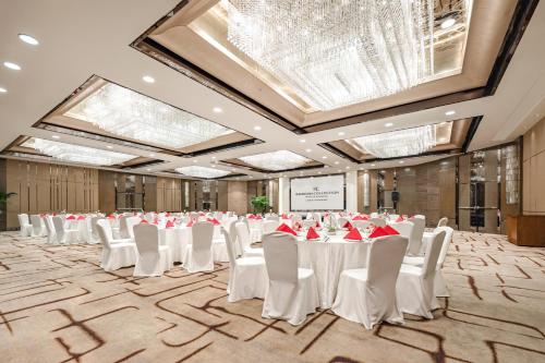 a banquet hall with white tables and white chairs at Radisson Collection Hotel, Yangtze Shanghai in Shanghai