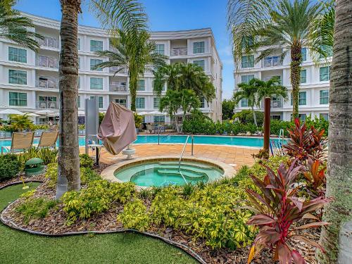 a resort with a pool and palm trees and a building at Pet friendly in Orlando area near Disney and ESPN Center in Orlando