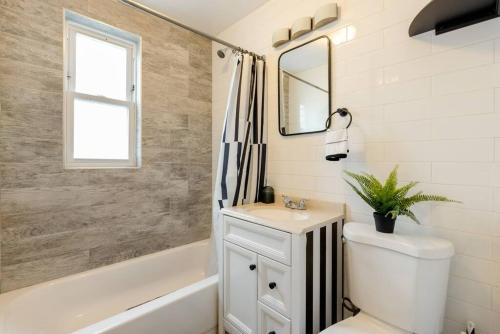 a white bathroom with a sink and a mirror at ZEN RETREAT in Brooklyn