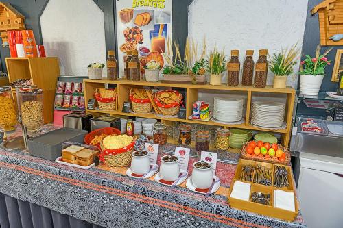 a counter with food and other items on it at Hotel des Alpes Bulle center in Bulle