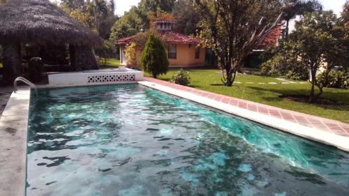 a swimming pool in the yard of a house at Las Palmas in Tezoyuca