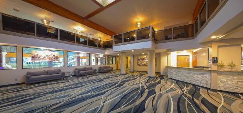 a large lobby with couches and tables in a building at Grand Marquis Waterpark Hotel & Suites in Wisconsin Dells