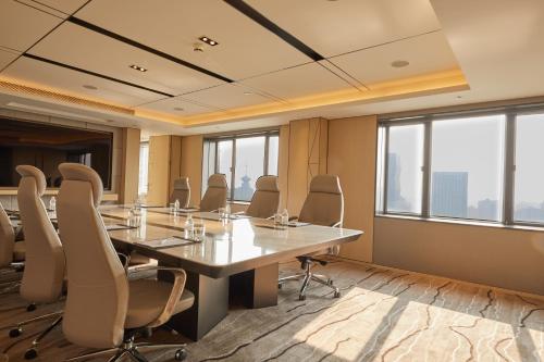 a conference room with a large table and chairs at Radisson Collection Hotel, Yangtze Shanghai in Shanghai