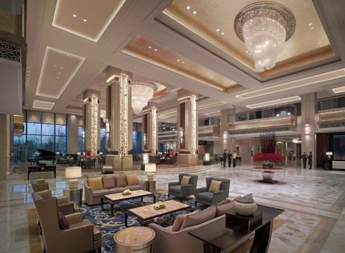 a lobby of a hotel with couches and tables at Shangri-La Shenyang in Shenyang