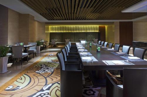 a long dining room with a long table and chairs at The Westin Qingdao - Instagrammable in Qingdao