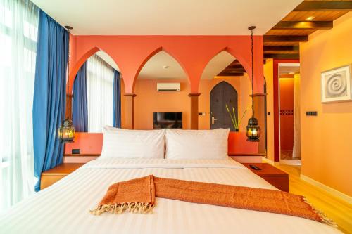 a bedroom with a large bed with orange walls at Amber Boutique Silom in Bangkok