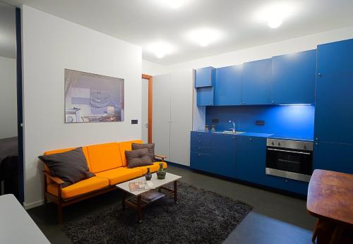 a living room with a yellow couch and blue cabinets at Astro Apartments in Reykjavík