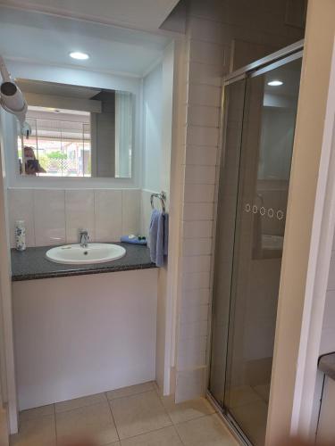 a bathroom with a sink and a shower at Peterborough Motel in Peterborough