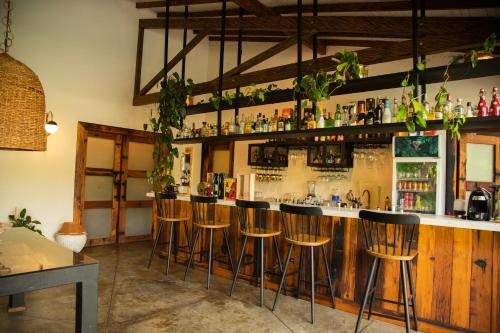 a bar with bar stools in a room at El Rio Hotel in Doradal