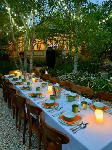 a long table with plates and candles on it at The Eaglehawk Country House Hotel - Rent your own Hotel in Maldon