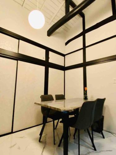 a dining room with a table and chairs at リベラ小波月古民家再生 海岸横プライベートビーチ並み in Iwada