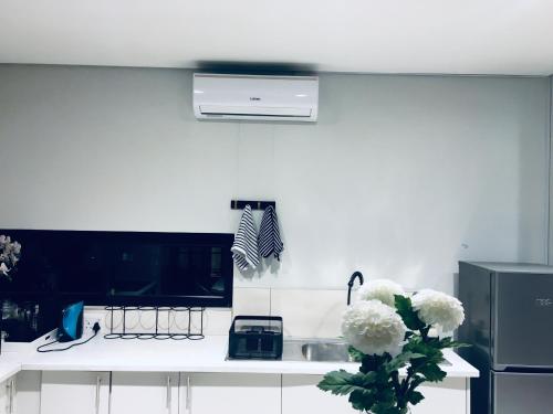 a white kitchen with a sink and a stove at DEE-LOFT 53 in Windhoek