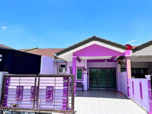 a pink house with a gate in front of it at Raina Muslim Homestay Perlis in Arau