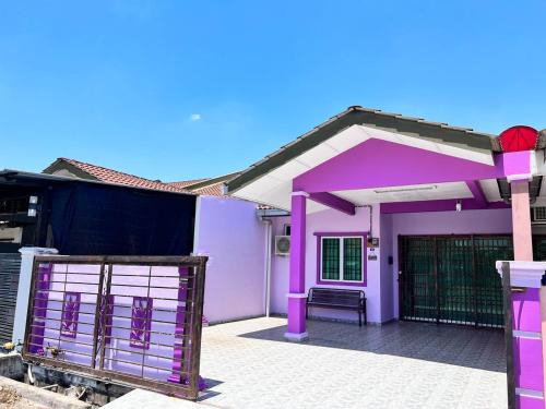 a pink house with a gate in front of it at Raina Muslim Homestay Perlis in Arau