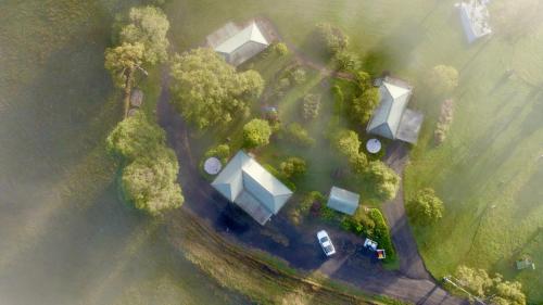 an overhead view of a park with trees and buildings at The Big Bell Farm in Kangaroo Valley