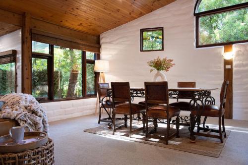 a dining room with a table and chairs at Woodland Cottage in Daylesford