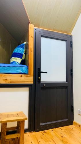 a room with a door and a bed and a table at Hoang Giang Homestay in Ninh Binh