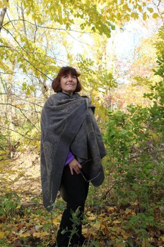 a woman standing in the woods wearing a blanket at EUDORA, KS in De Soto