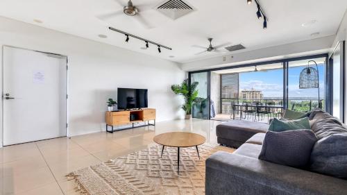 a living room with a couch and a table at Darwin Waterfront Short Stay Apartments in Darwin