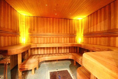 a sauna with wooden benches and a table in it at Grand Rose SPA Hotel in Kuressaare