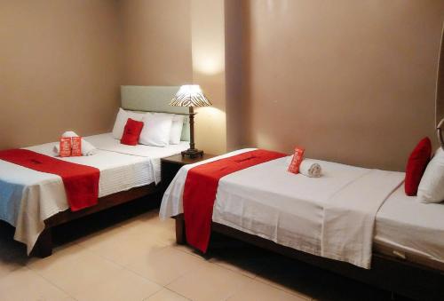 a hotel room with two beds with red packets on them at RedDoorz Plus New Era Budget Hotel Mabolo former RedDoorz near Landers Superstore Cebu City in Cebu City