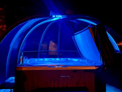 a tub with a blue lighting on top of it at Gîte de Pampe Lune & Spa in Pampelonne