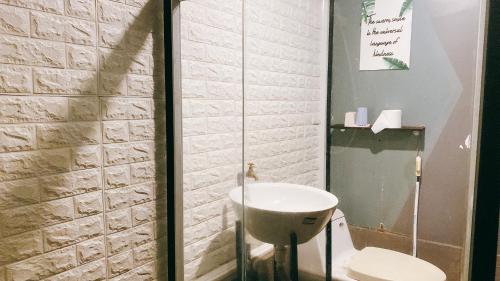 a bathroom with a toilet and a sink at Cozy Room@SaiGon in Ho Chi Minh City