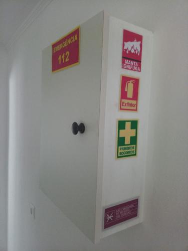 a room with a door with signs on it at Ginjals 67 in Almargem do Bispo