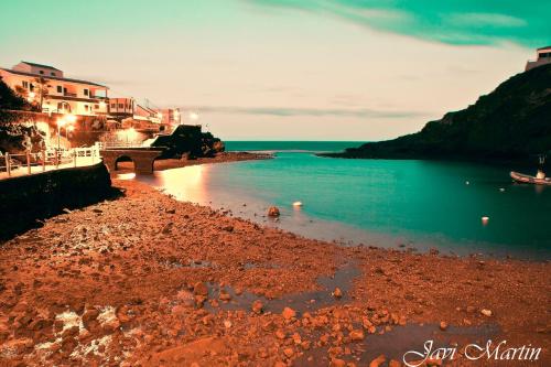 a beach with a bridge and a body of water at EL JORADO in Tamaduste