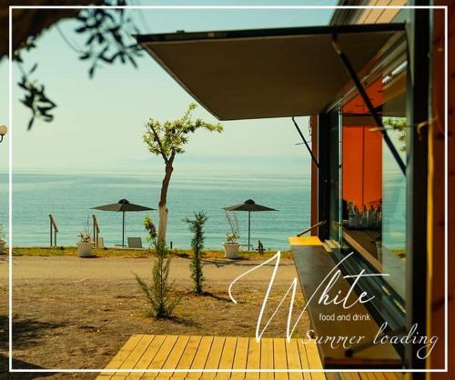 a view of a beach with umbrellas and the ocean at Elimnion Resort in Khronia