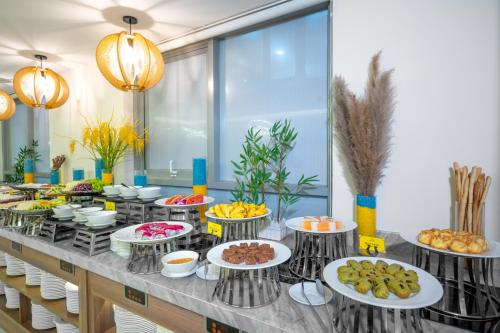 a buffet line with many plates of food at Libra Hotel Nha Trang in Nha Trang