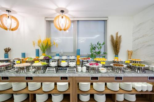 a buffet with a lot of food on plates at Libra Hotel Nha Trang in Nha Trang