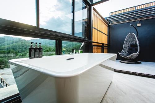 a bathroom with a large white sink and a window at D’Endless Resotel in Baen