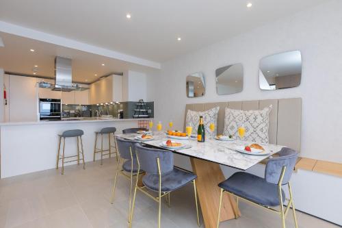 a dining room and kitchen with a table and chairs at Monowai Heights in St Ives